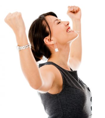 Excited business woman celebrating a triumph - isolated over a white background